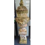 A large weathered Victorian painted terracotta lidded urn on plinth base, diameter 64cm, height