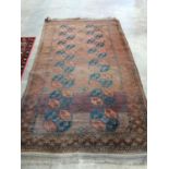 An Afghan red ground rug, 240 x 146cm