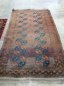 An Afghan red ground rug, 240 x 146cm