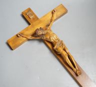 A carved crucifix and a framed metal Peruvian colonial crucifix, 50cm