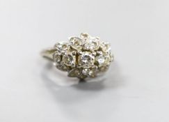 A white metal and three stone diamond ring with diamond cluster setting, size M, gross weight 4.4