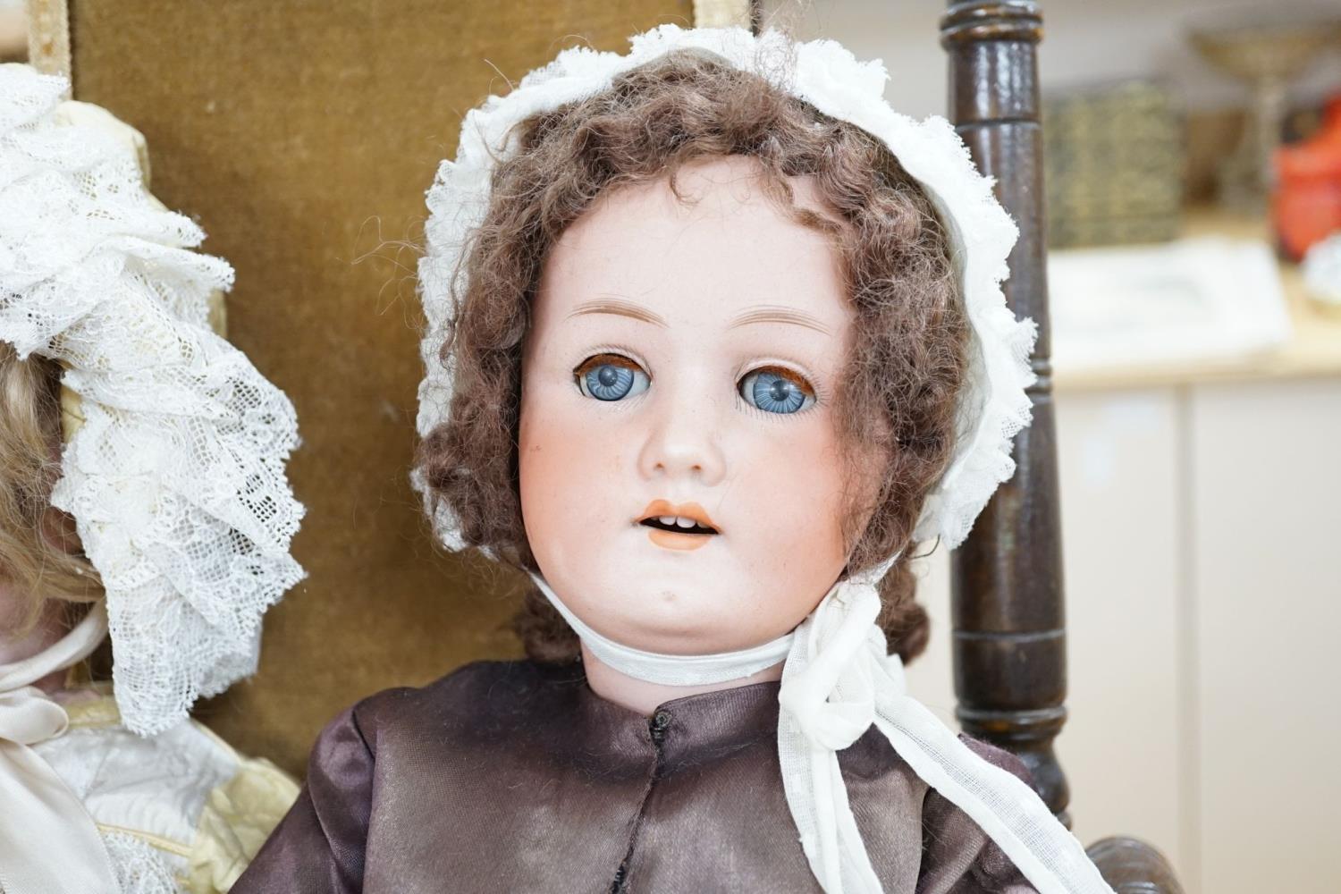 A Heubach, Koppelsdorf 250 bisque doll and an Armand Marseille 390 bisque doll, seated in turned - Image 3 of 5