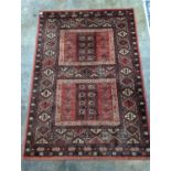 A Caucasian red ground rug, 190 x 136cm