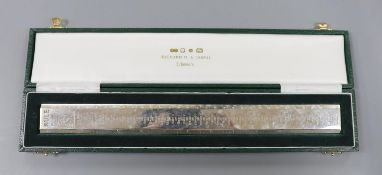 A cased modern Britannia standard silver 'Rule' ruler, engraved with the names and dates of the