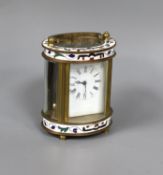 An oval brass and champleve enamel carriage timepiece, 9cm