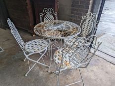 A circular painted wrought iron garden table, diameter 75cm, height 75cm together with four