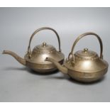 A pair of bronze teapots