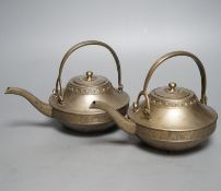 A pair of bronze teapots