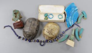 A small collection of Egyptian artefacts including necklace, scarabs, rings and a later scarab