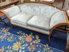 A 19th century Biedermier style part ebonised two seater scroll arm settee recently upholstered in