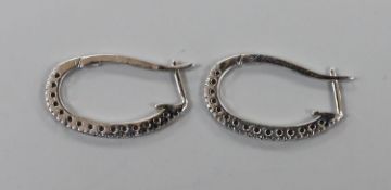 A pair of modern white metal and diamond chip set half hoop earrings, 27mm,gross weight 5.9 grams.