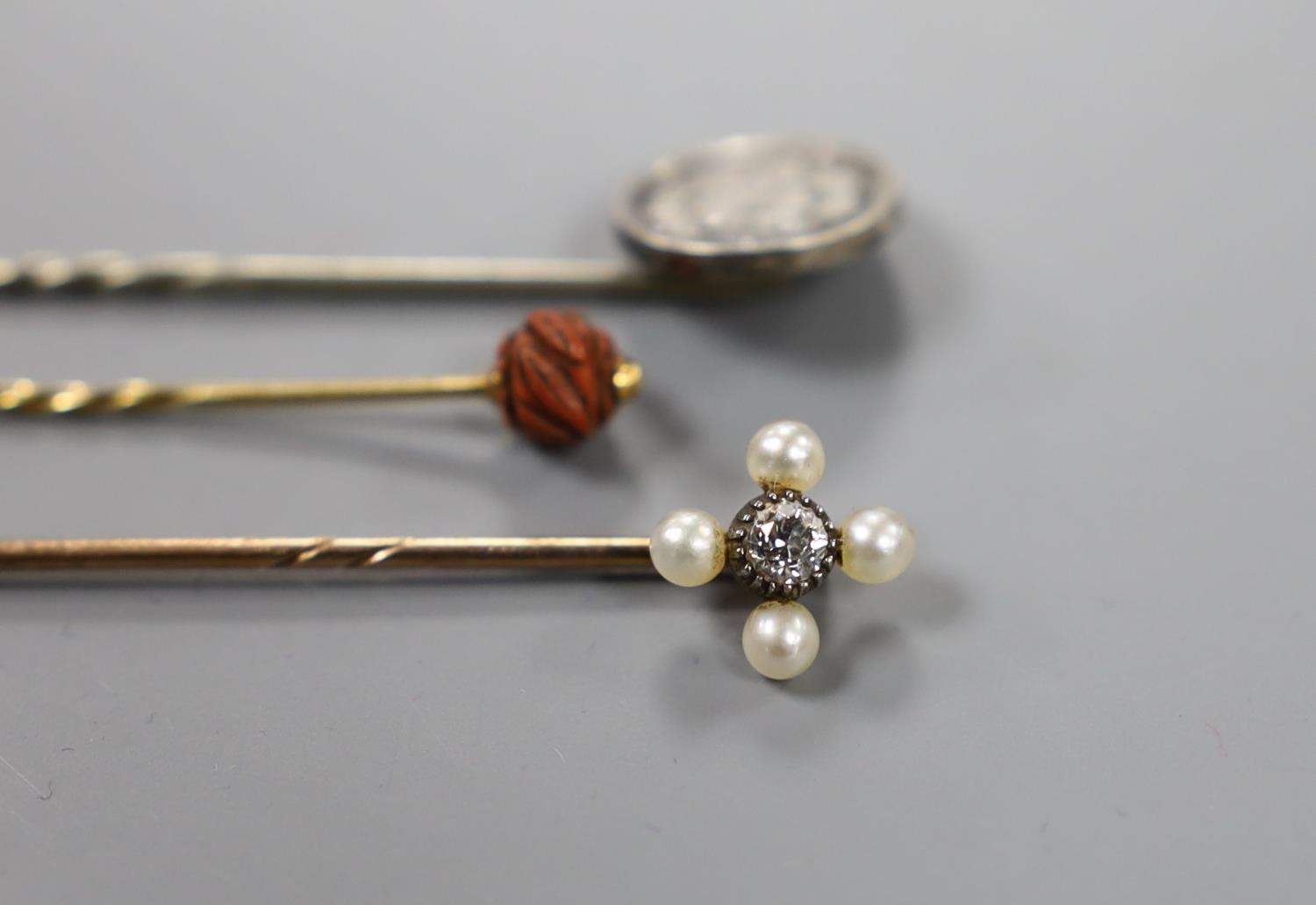 An Edwardian yellow metal, seed pearl and diamond set stick pin, 57mm and two other stick pins. - Image 2 of 5