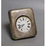 An early 20th century hammered silver mounted travelling watch case, marks rubbed, with keyless