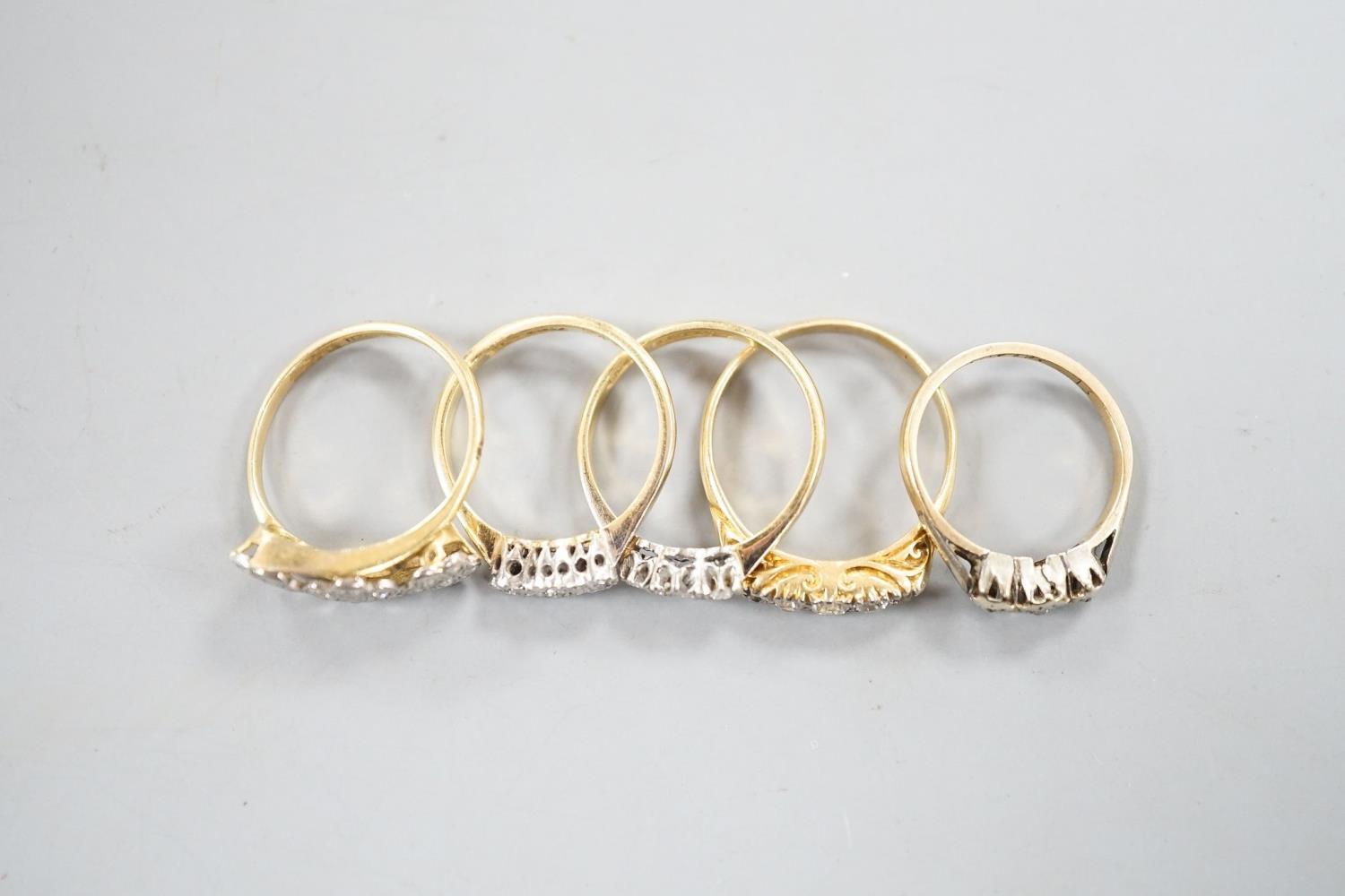 An early 20th century yellow metal and graduated five stone diamond set half hoop ring, size Q, - Image 6 of 6