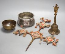 A Himalayan brass bell and bowl, a woolwork finial, 43 cm high, an Islamic tinned metal censer (4)