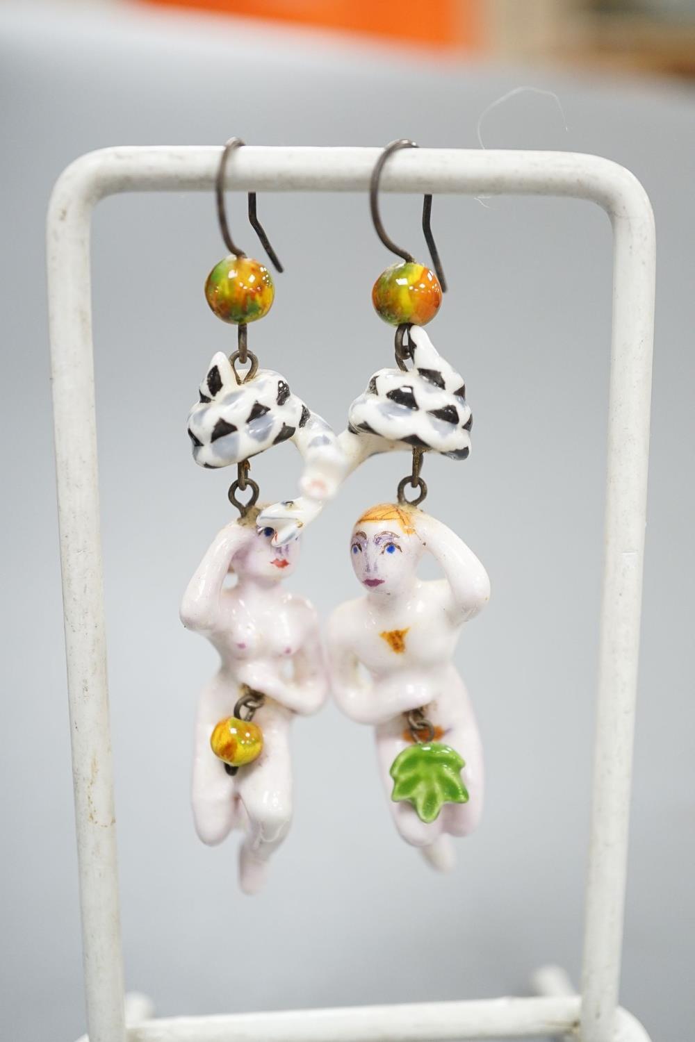 A pair of painted porcelain 'Adam & Eve with serpent' drop earrings, 62mm - Image 2 of 5