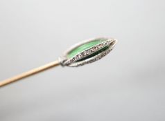 An early 20th century yellow metal stick pin, with rose cut diamond and green enamel set terminal,