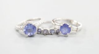 Two modern 18k white metal, tanzanite and diamond set dress rings, size J, gross 8.3 grams and a