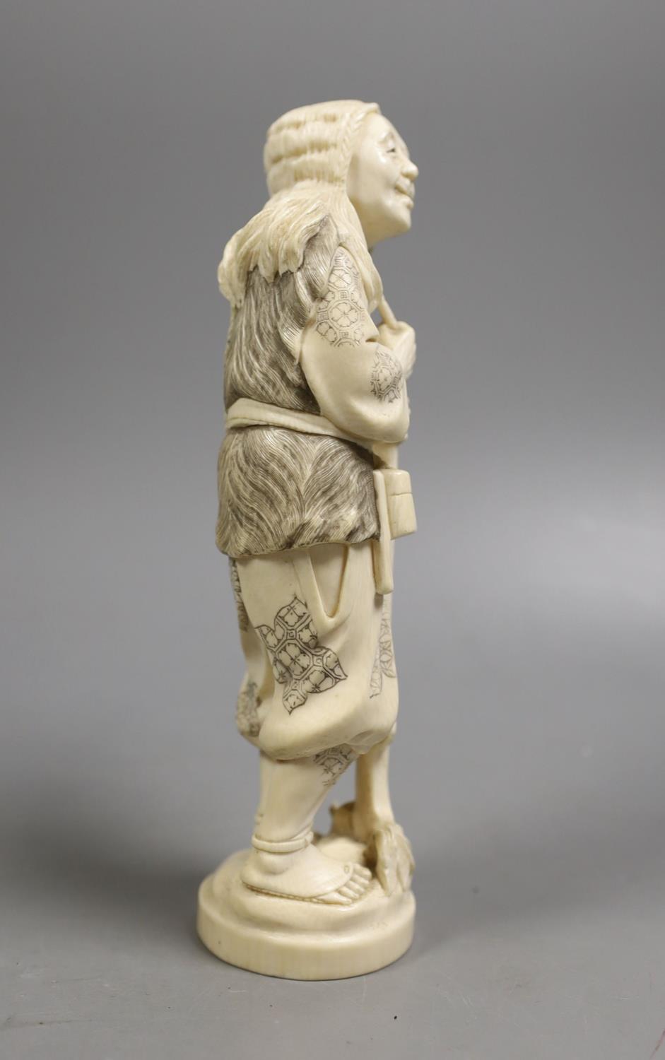 A Japanese ivory figure of a huntsman, early 20th century,21 cms high. - Image 3 of 4
