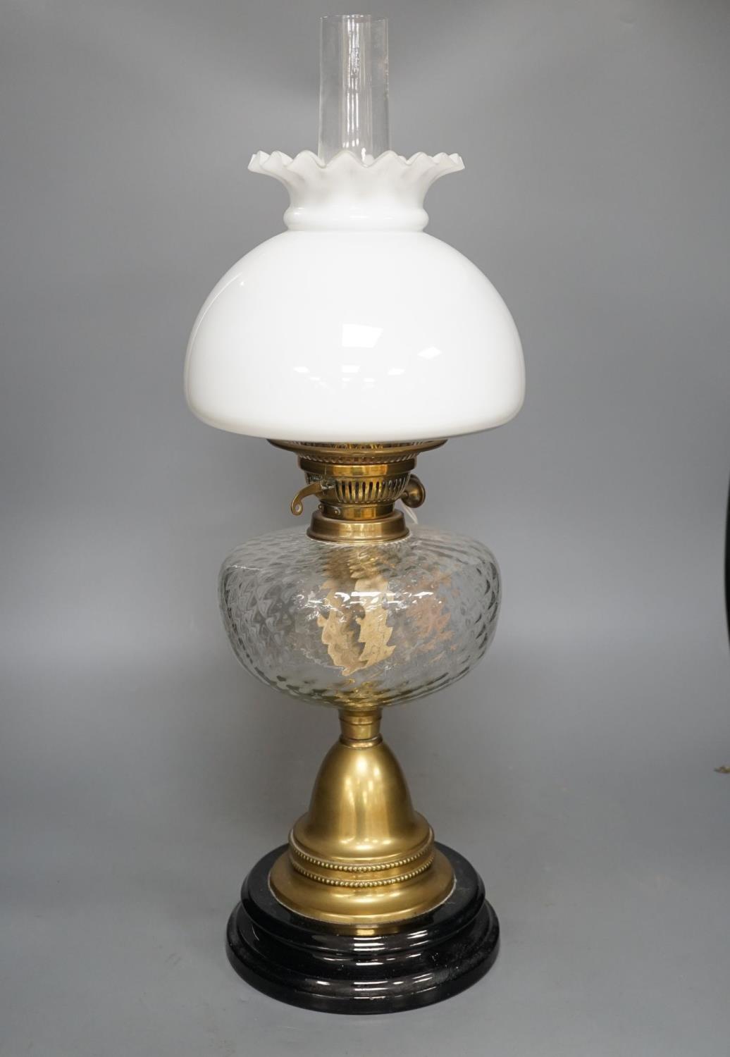 A brass oil lamp with opaque shade 60cm total height