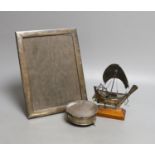 A George V silver mounted rectangular photograph frame, 24.2cm, a 1930's silver trinket box and a
