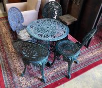 A Victorian style circular painted aluminium garden table, diameter 66cm, height 66cm and four