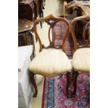 A set of five Victorian mahogany dining chairs with interlaced backs and cabriole legs