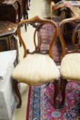 A set of five Victorian mahogany dining chairs with interlaced backs and cabriole legs