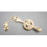 A 19th century Chinese export ivory puzzle ball.31 cms long including chain.