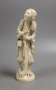 A Japanese ivory figure of a huntsman, early 20th century,21 cms high.