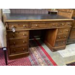 A Victorian mahogany pedestal desk, fitted with nine small drawers, length 138cm, depth 68cm, height