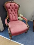 A Victorian carved walnut open armchair