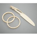 A late 19th century carved ivory ‘parrot’ paper knife and two Japanese carved Ivory bangles,paper
