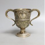 A George III provincial silver two handled pedestal cup, with later embossed decoration, Langlands &