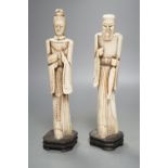 A pair of Chinese carved bone figuresTallest 27 cms high.