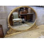 A Victorian style gilt framed overmantel mirror with oval plate, width 172cm, height 114cm
