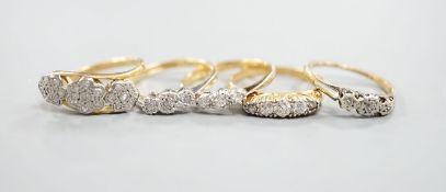 An early 20th century yellow metal and graduated five stone diamond set half hoop ring, size Q,