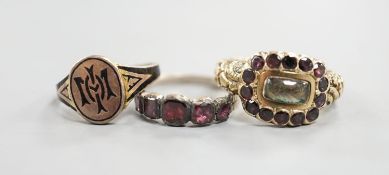 A late George III yellow metal, garnet and plaited hair mounted mourning ring, inscribed 'Ann