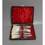 A cased set of six pairs of Edwardian mother of pearl handled silver dessert eaters, Sheffield,