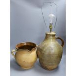 A stoneware two handled jug and a table lamp base. Table lamp 37 cms high.