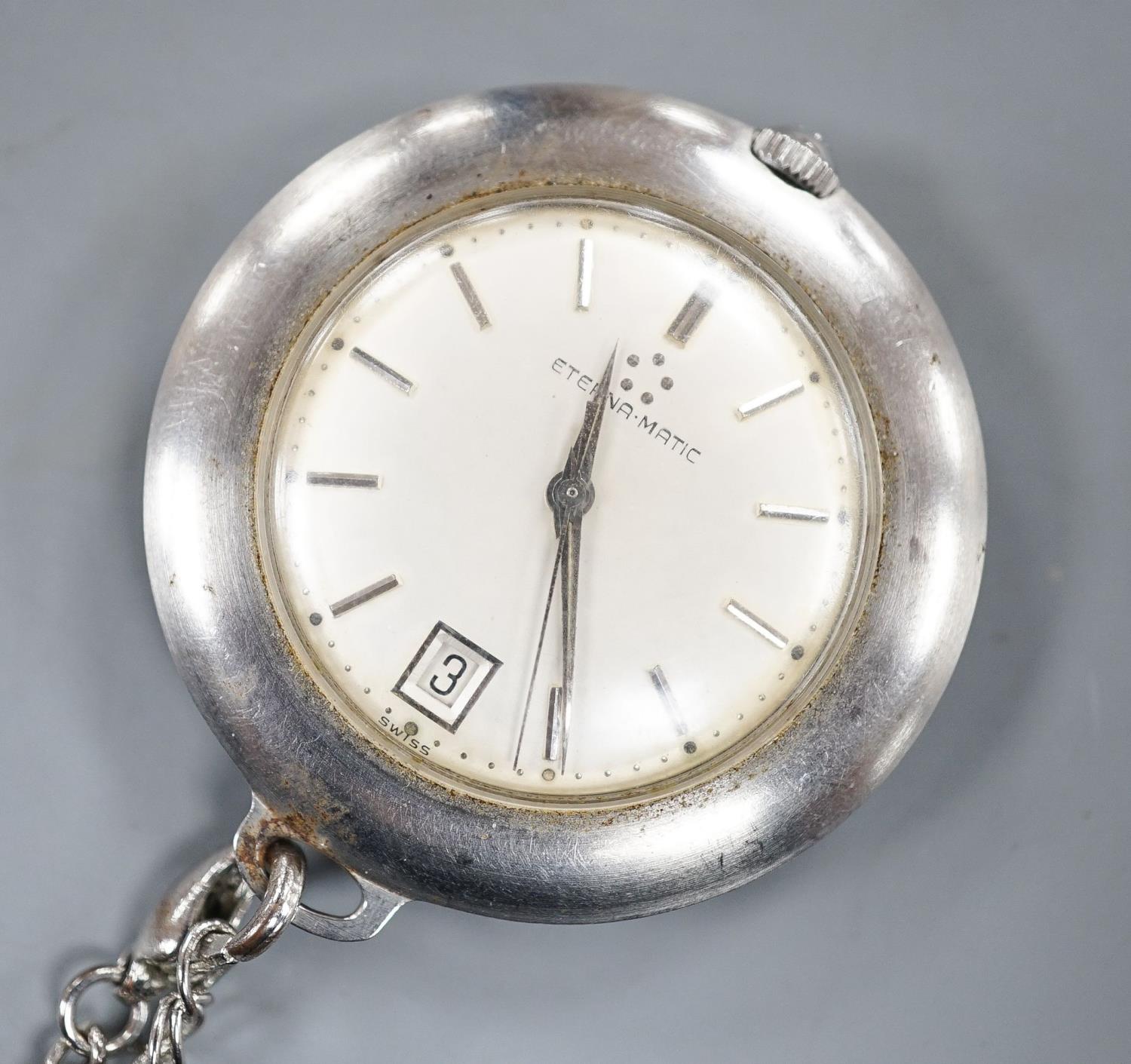 A base metal cased Eterna-matic manual wind dress pocket watch, with date aperture, on a metal