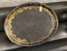 A Victorian oval gilt decorated black lacquered papier-mache tray, length 79cm, width 62cm