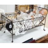 3 Armand Marseille bisque head dolls with sleeping eyes and 4 others in a wrought iron dolls crib