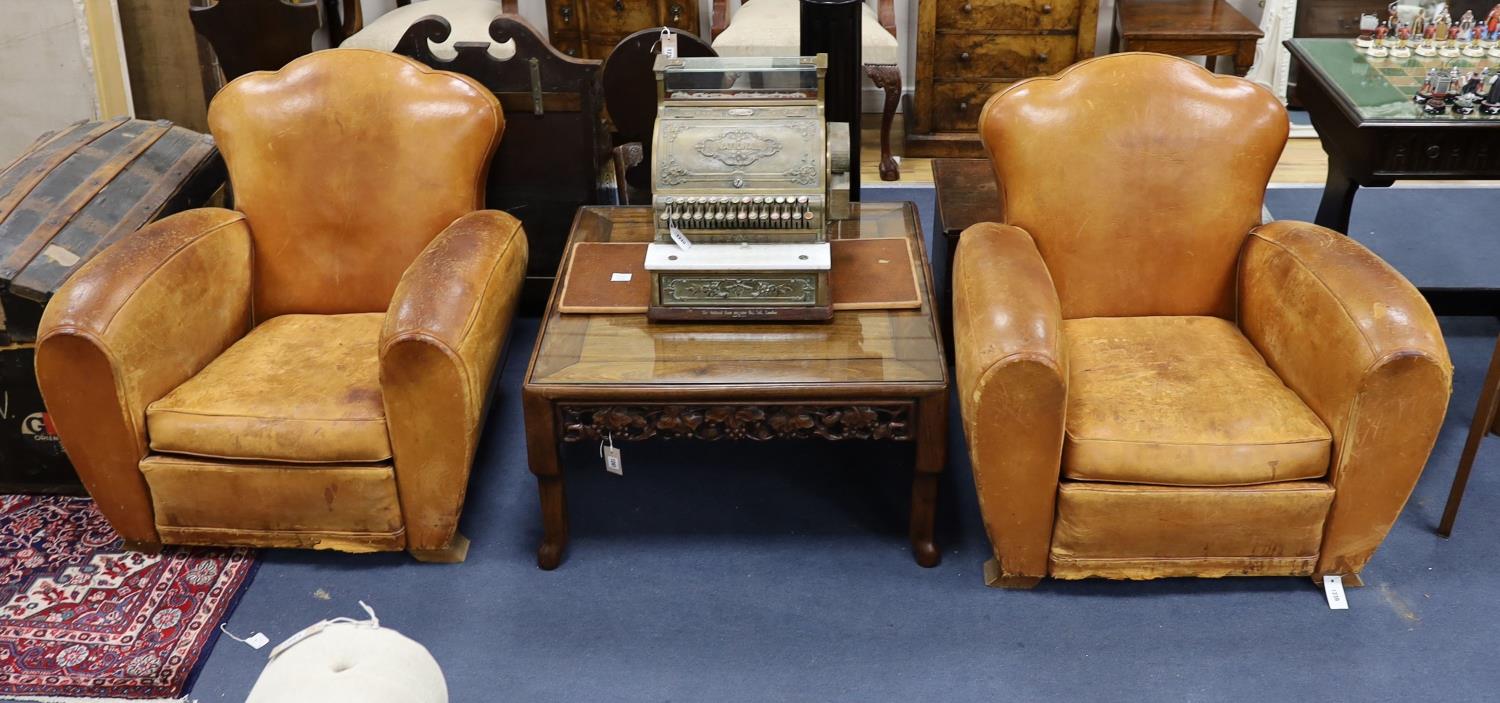 A pair of mid 20th century French tan leather club armchairs, width 90cm, depth 84cm, height 80cm