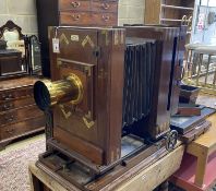 An early 20th century Hunter-Penrose Ltd. brass mounted mahogany studio plate camera, with 4in.