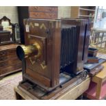 An early 20th century Hunter-Penrose Ltd. brass mounted mahogany studio plate camera, with 4in.