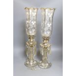 A pair of late 19th century French white-enamelled glass lustre hung storm lamps, 55cms high.