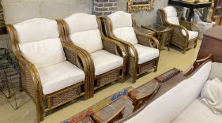 A caned bamboo six piece conservatory suite comprising four armchairs with loose cushions, width