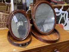 Two 19th century oval mahogany travelling toilet mirrors, larger width 36cm, height 46cm