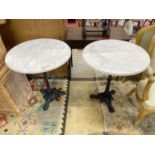 A pair of Victorian style cast iron circular marble topped pub tables, diameter 64cm, height 72cm